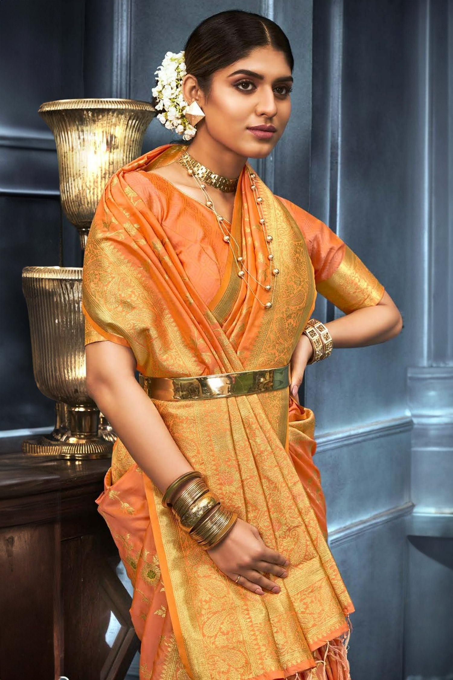 Vibrant Orange Saree With Floral And Paisley Motifs